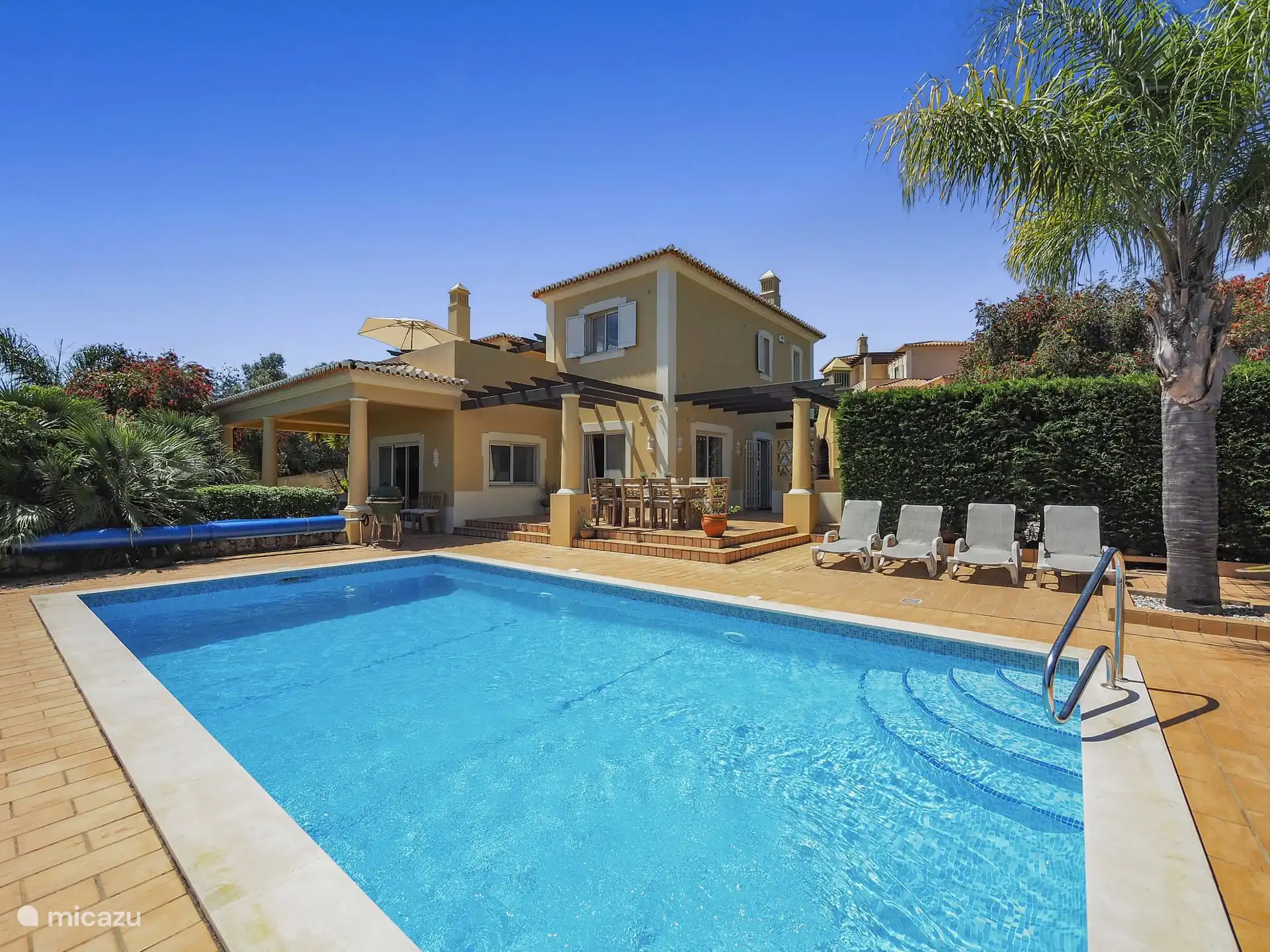 Swimming pool sunbeds and terrace