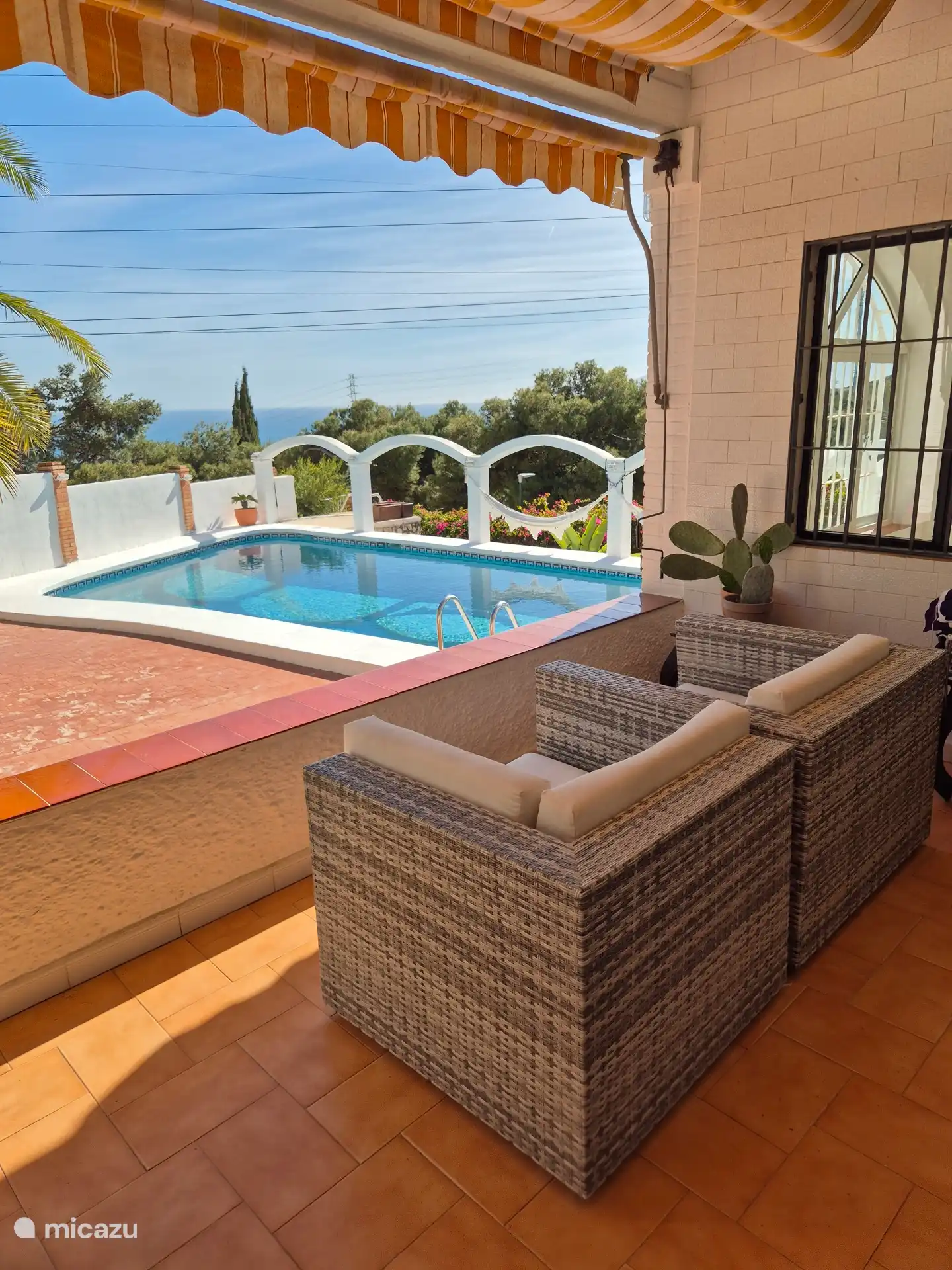The veranda is directly adjacent to the living room. From the veranda you have a beautiful view of the sand and the pool. On the covered veranda there are two very comfortable large armchairs.