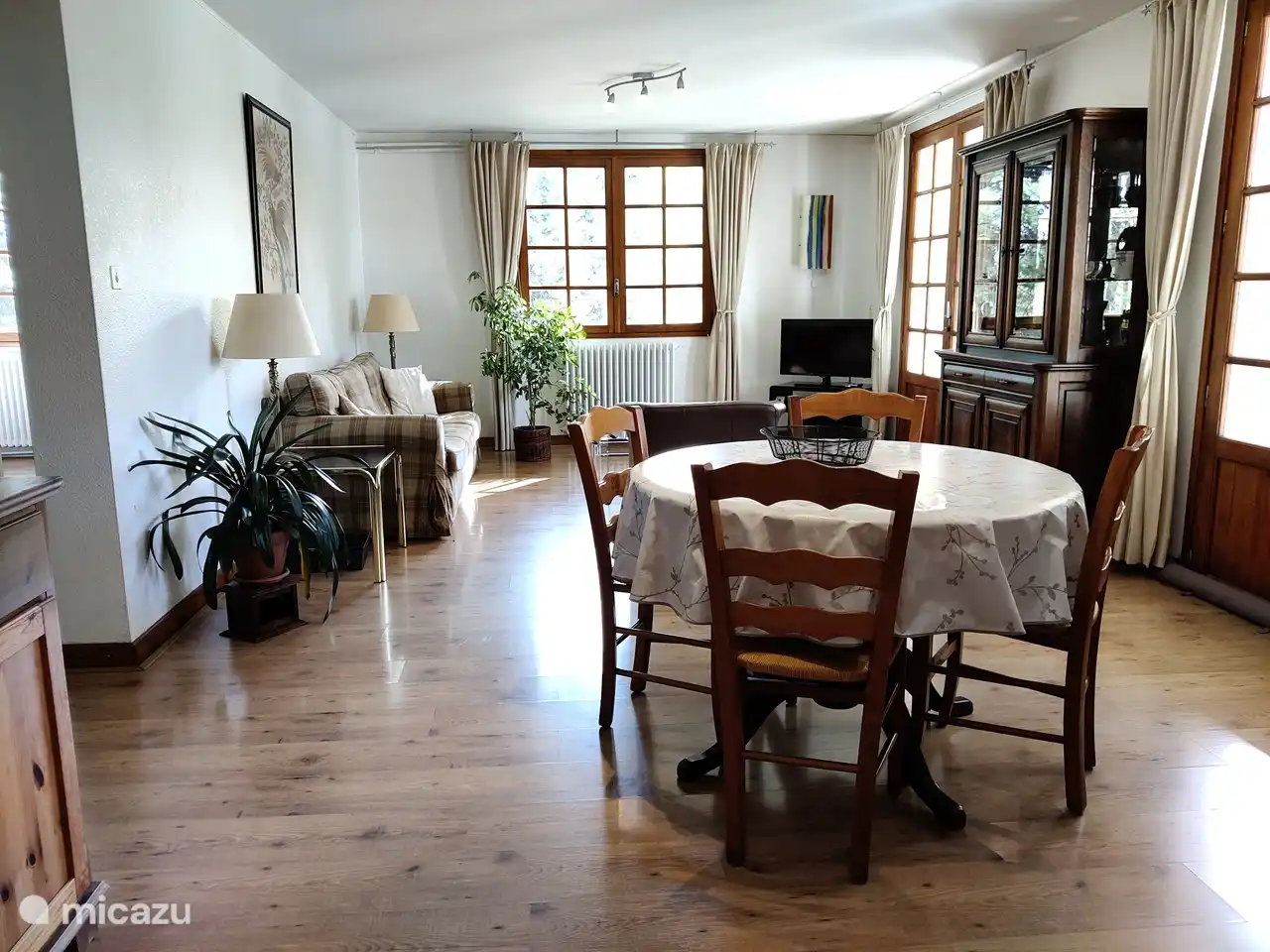 The living room with sitting area and dining table