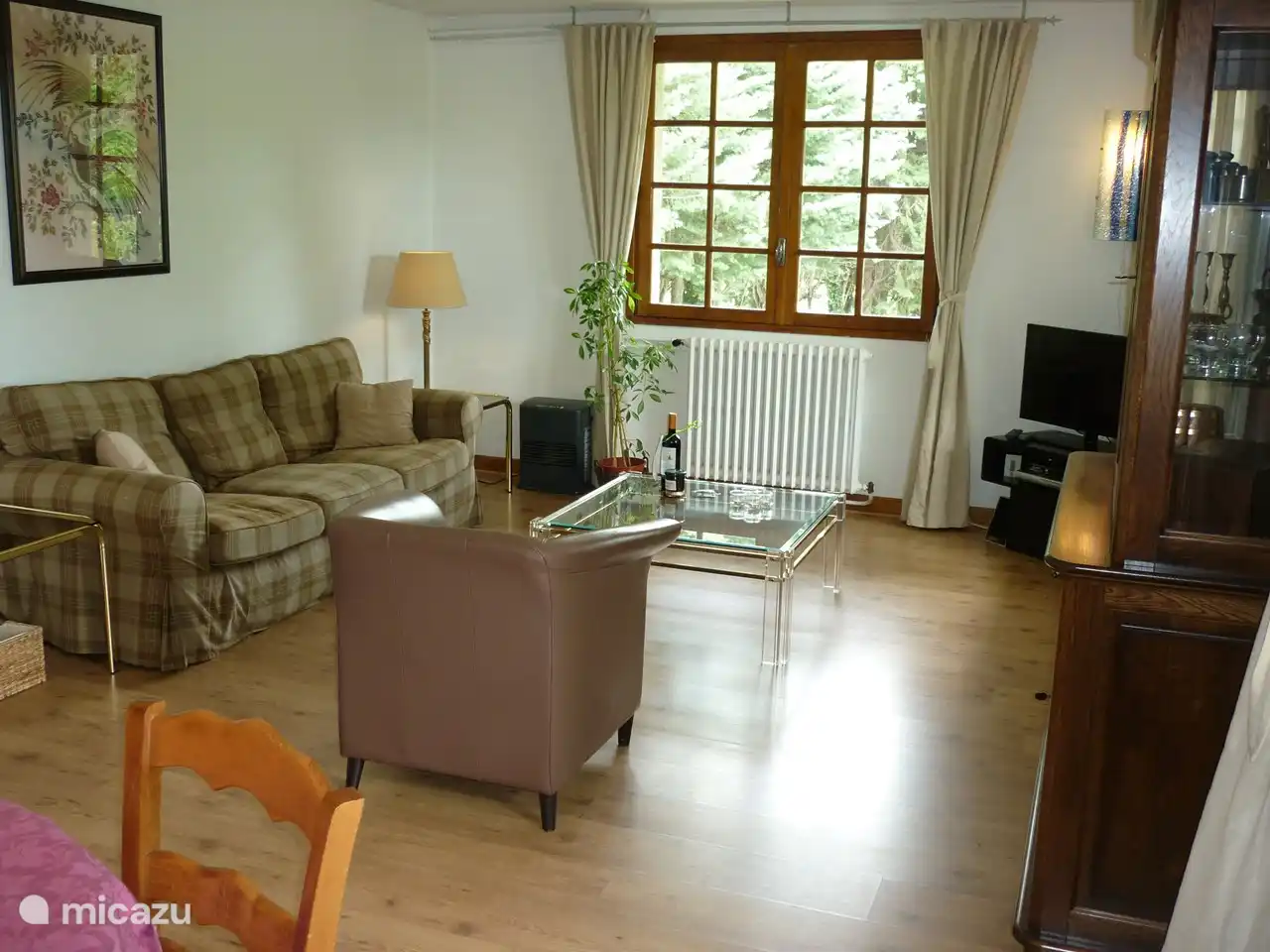 The living room of the apartment with the sitting area and the dining table