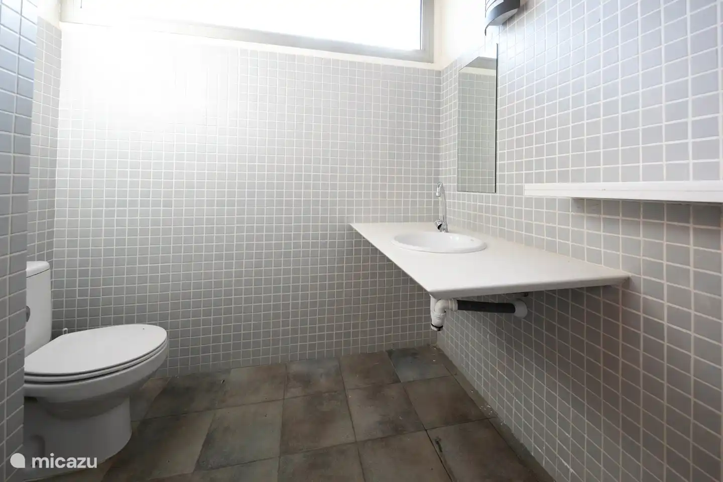 separate toilet next to the pool, at the porch