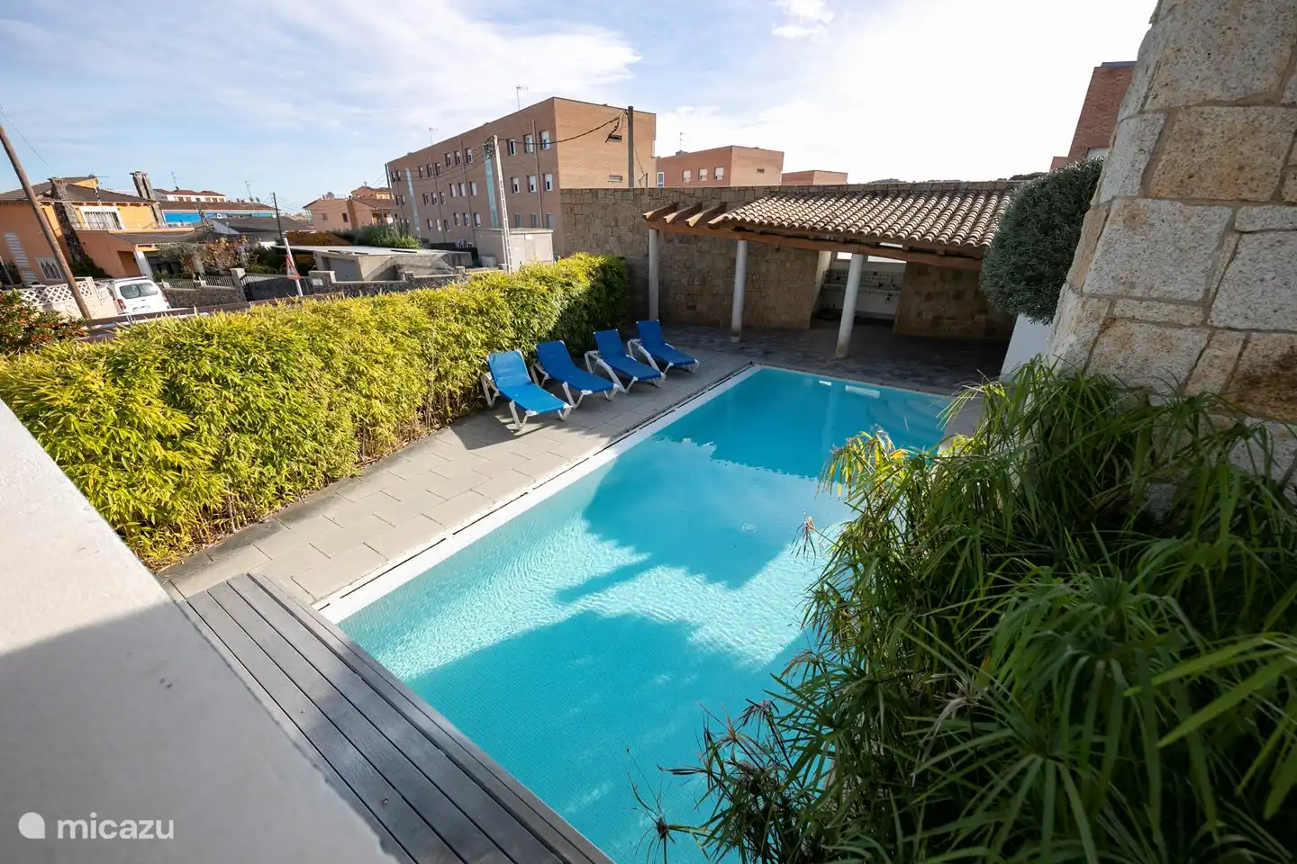 swimming pool with a porch and bbq