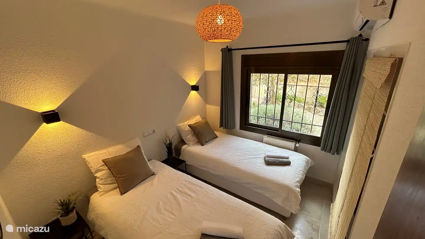 Bedroom 2 - 2 single beds (200x90) air conditioning, mirror and mosquito net on the window