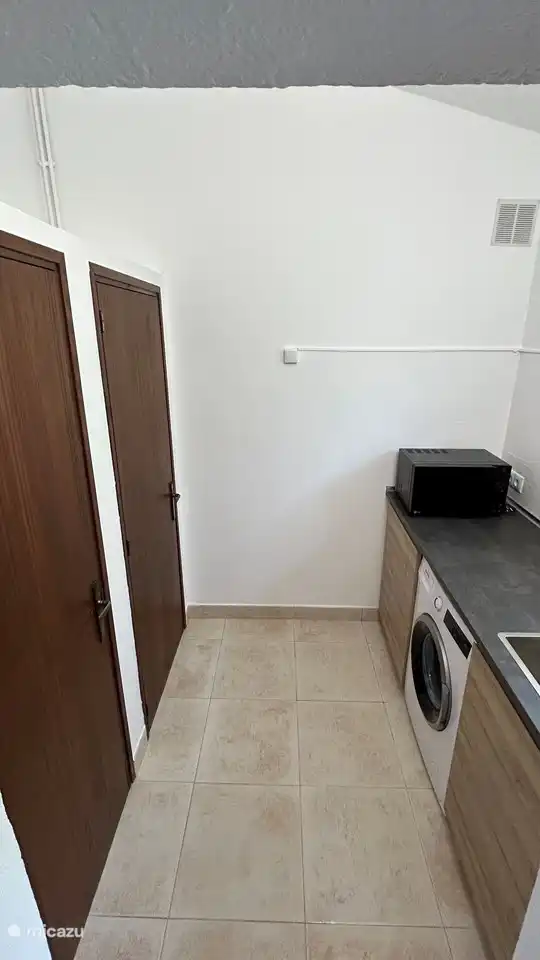 Utility room with washing machine and storage space