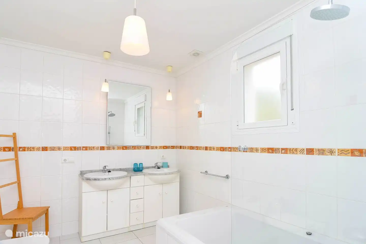 Spacious bathroom with sink, shower, bath and toilet.