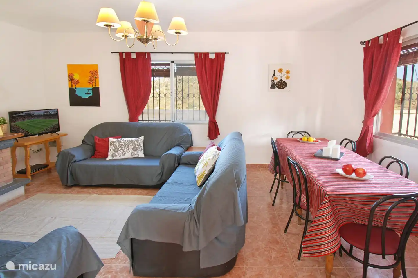 The living room has a dining table with chairs. All windows have mosquito nets and blinds.