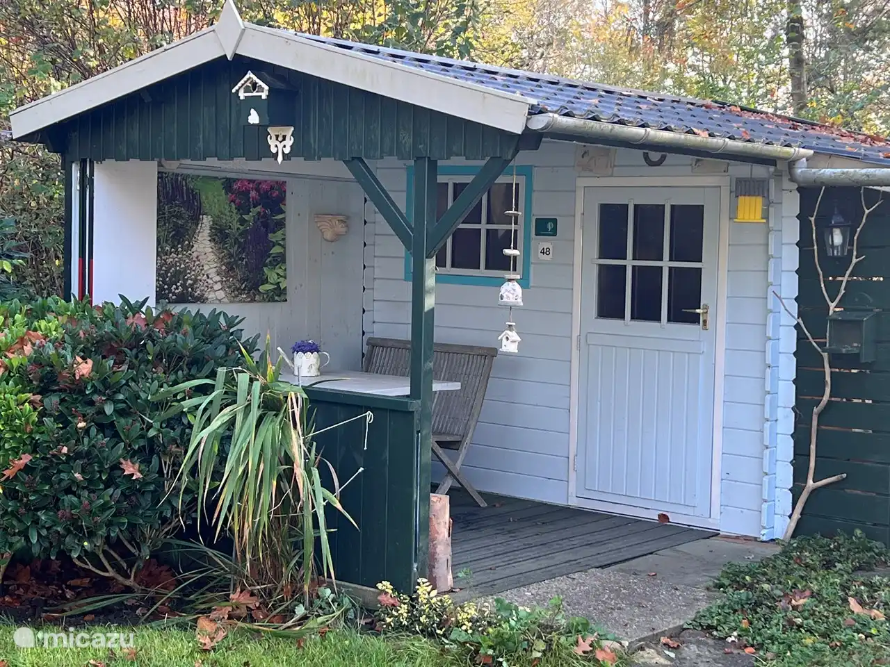 Garden shed with shutters open.