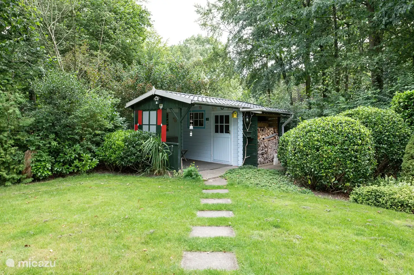 Garden shed for storing bicycles and for charging the batteries and storing firewood