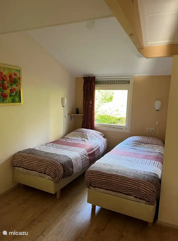 Bedroom 1 2 times 1 person box springs with storage cupboard for clothes.