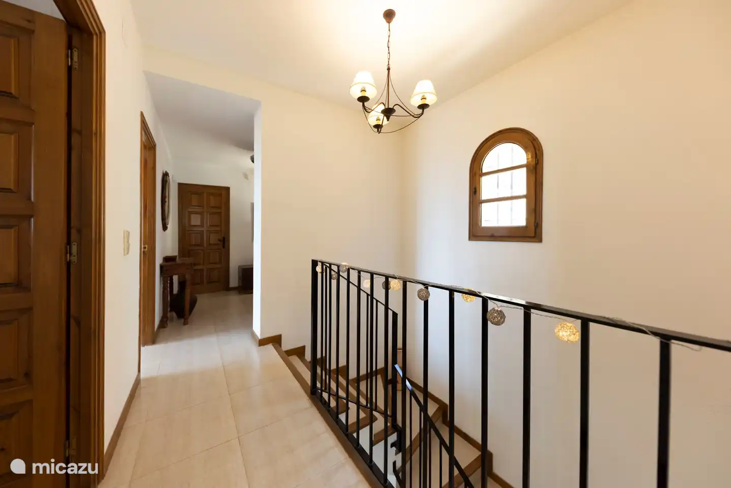 hallway at entrance where both bedrooms and bathroom are located, stairs to living room and kitchen