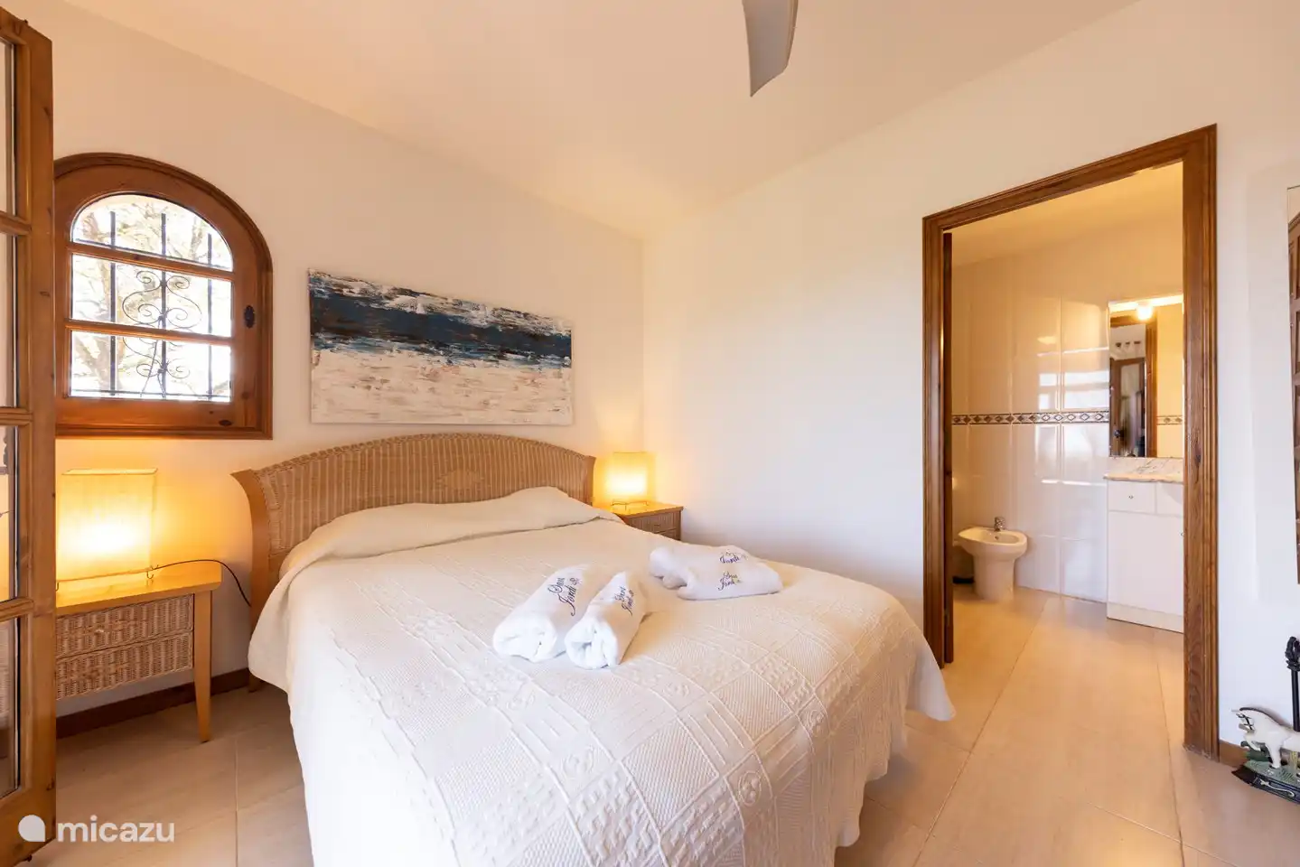 bedroom with en-suite bathroom and patio doors to the balcony