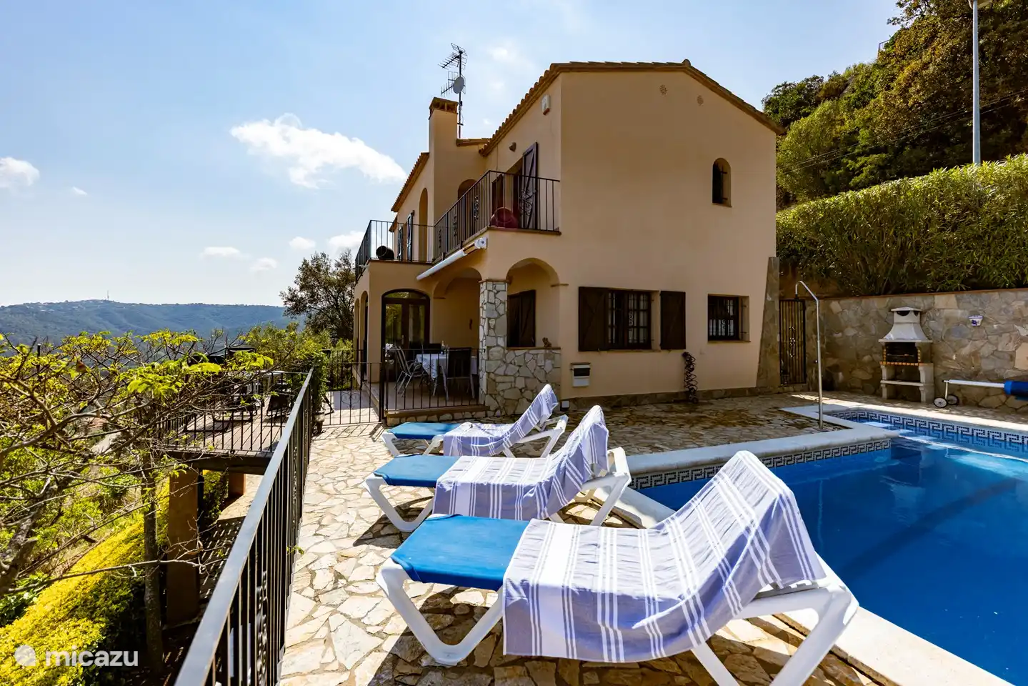 swimming pool next to the villa, with a gate that contains a child lock