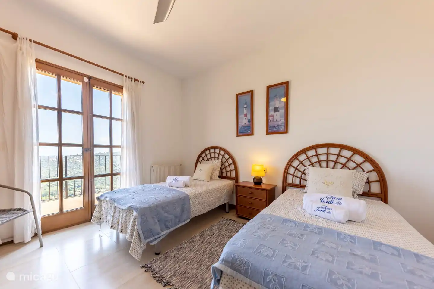Twin bedroom with patio doors to a balcony with stunning views