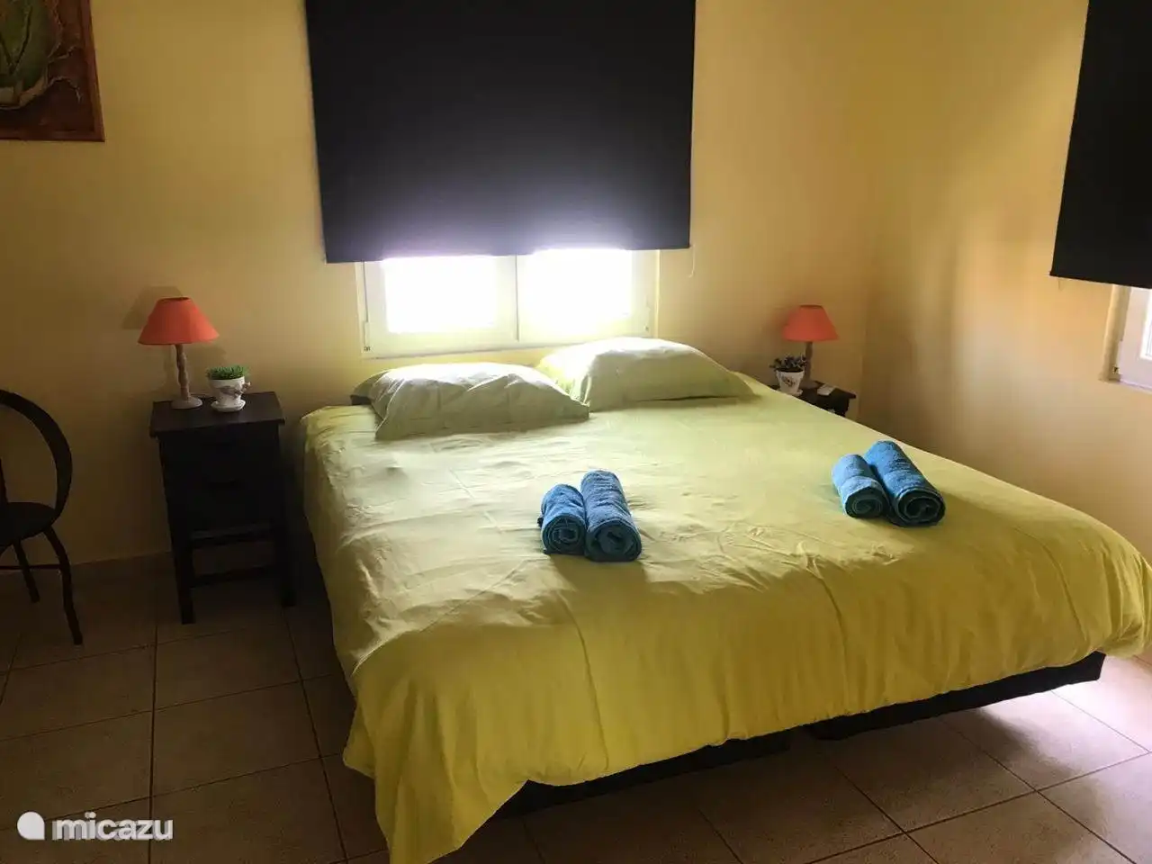 Bedroom with large closet with hanging and shelves, safe and bedside tables. Box spring and bathroom windows with mosquito nets air conditioning available