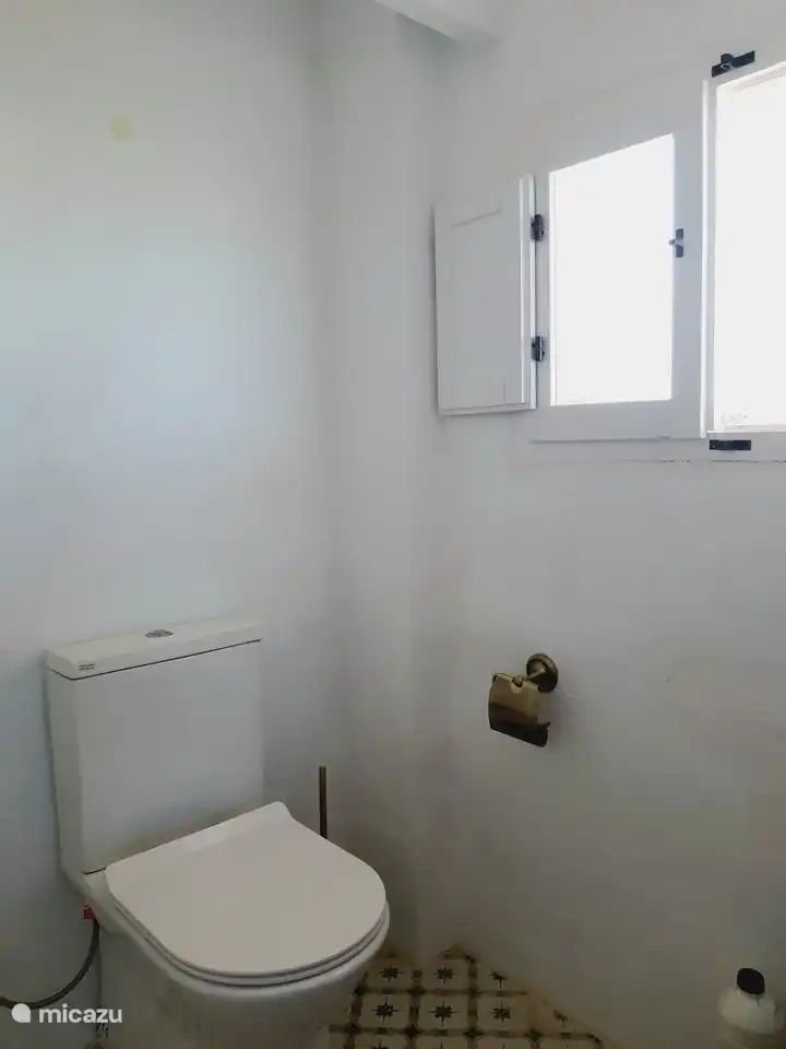 Toilet and washing machine upstairs by the roof terrace 