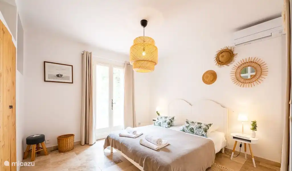 Spacious bedroom with whisper-quiet air conditioning and patio doors to the terrace.