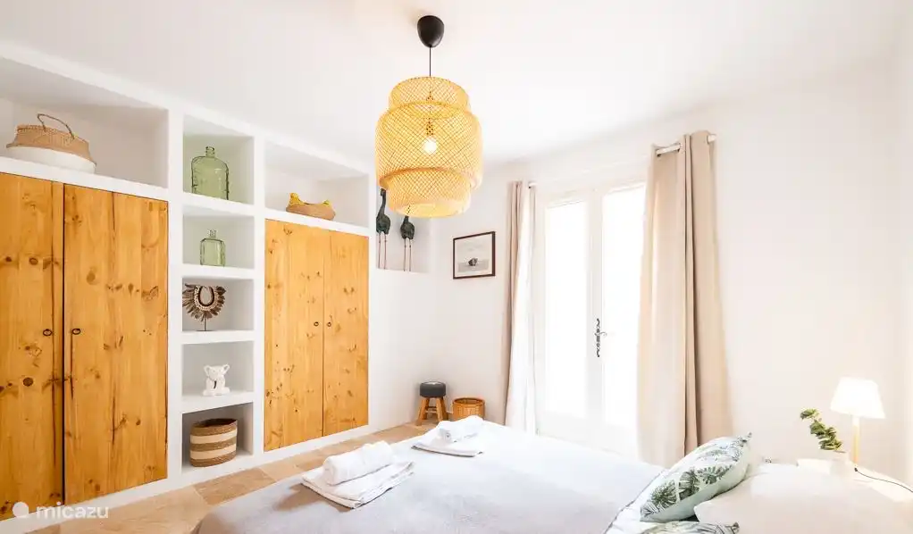 Spacious bedroom with whisper-quiet air conditioning and patio doors to the terrace.