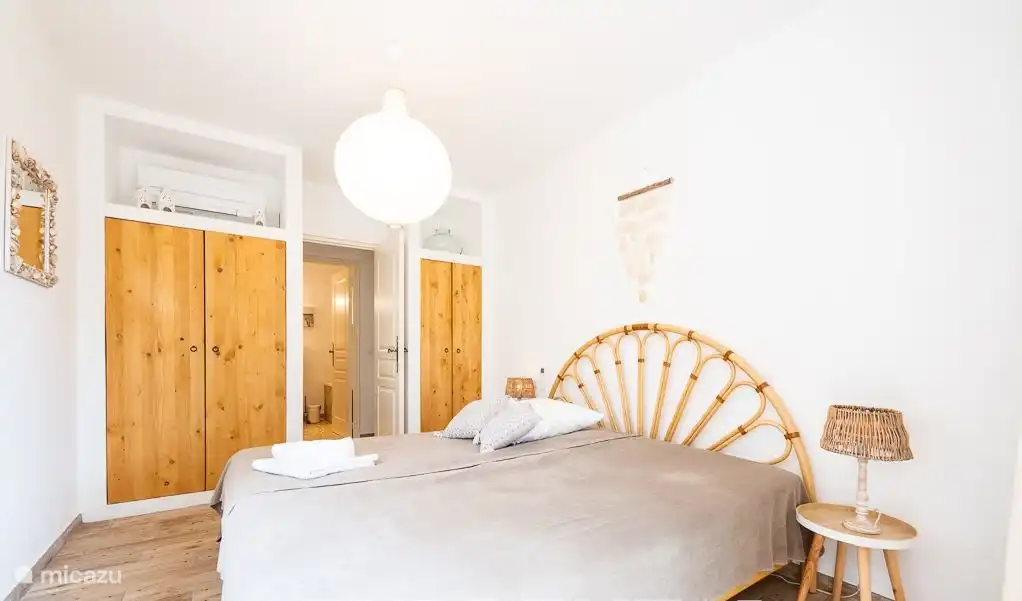 Spacious bedroom with whisper-quiet air conditioning and patio doors to the terrace.