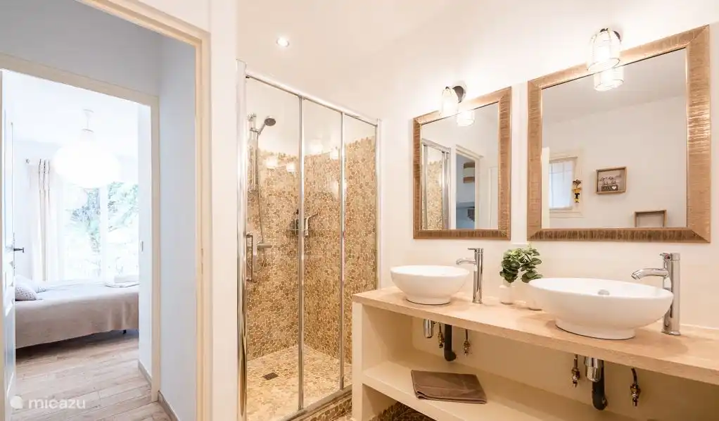 Bathroom with double sink, bath, shower and toilet.