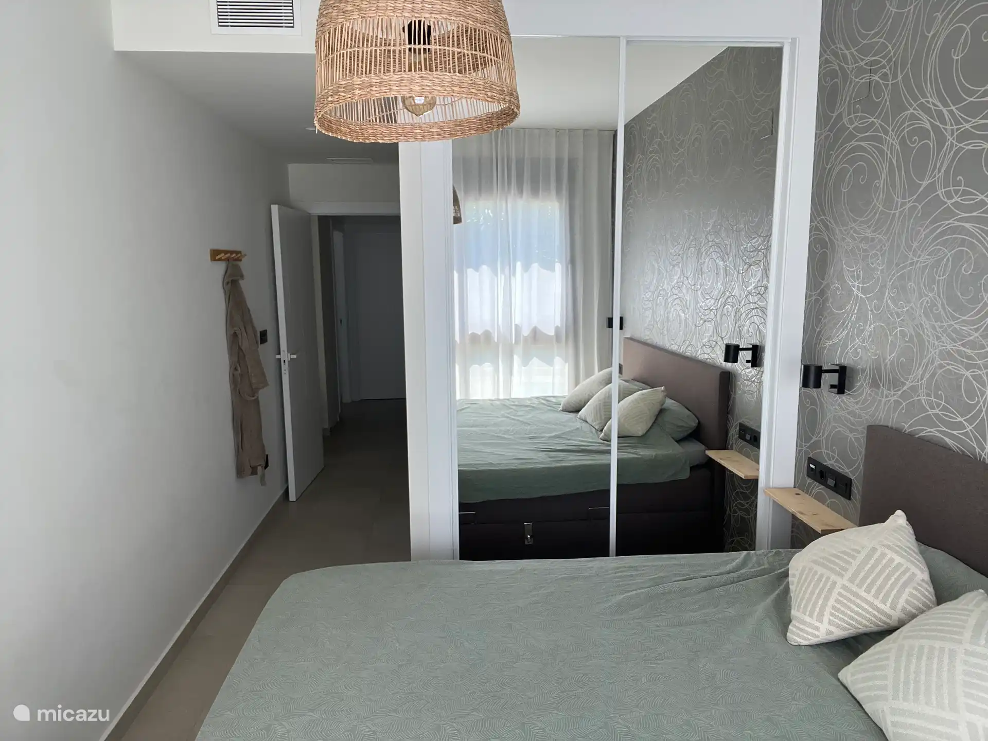 Master bedroom with ensuite bathroom overlooking the pool 