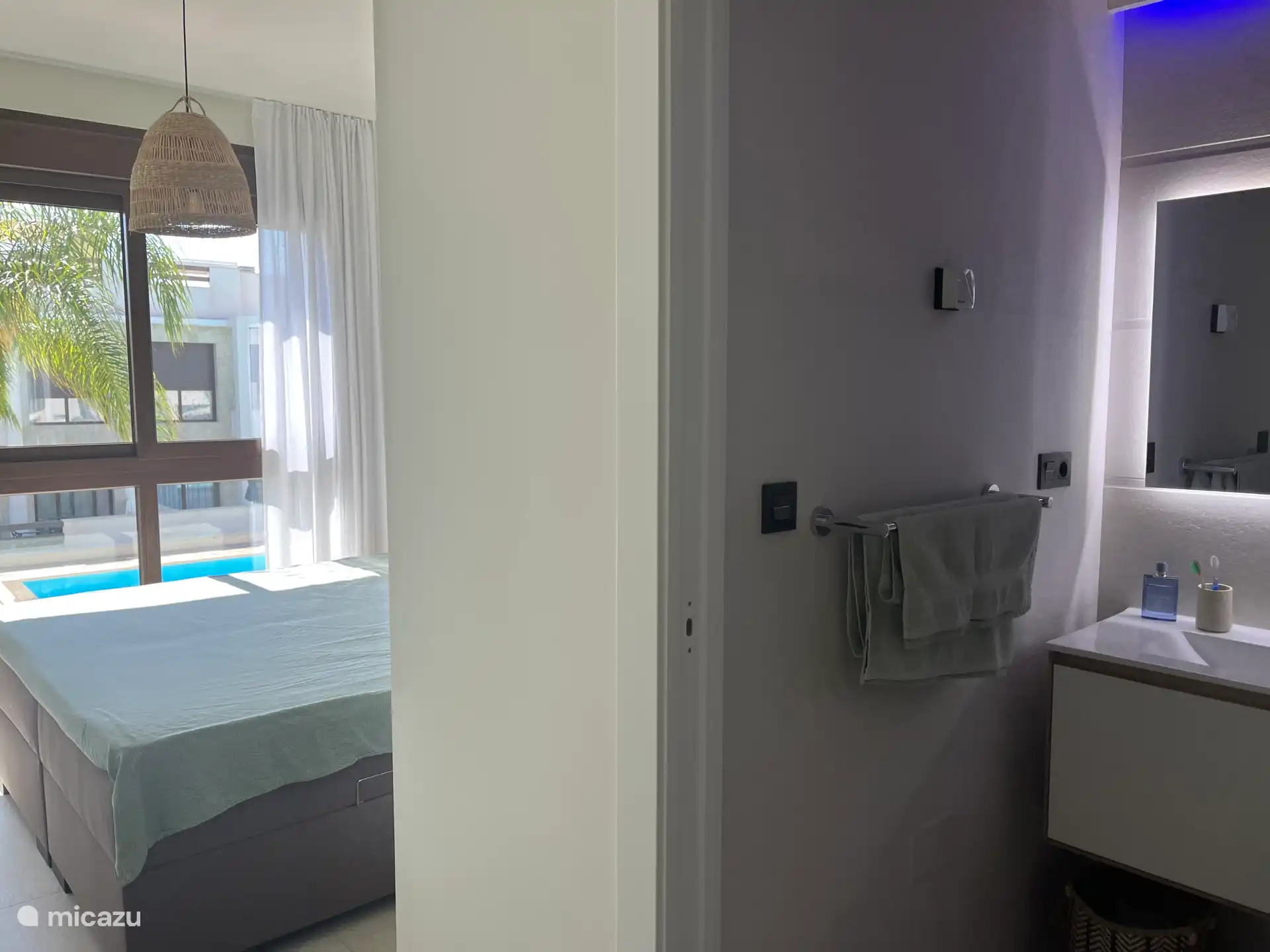 Master bedroom with ensuite bathroom overlooking the pool 