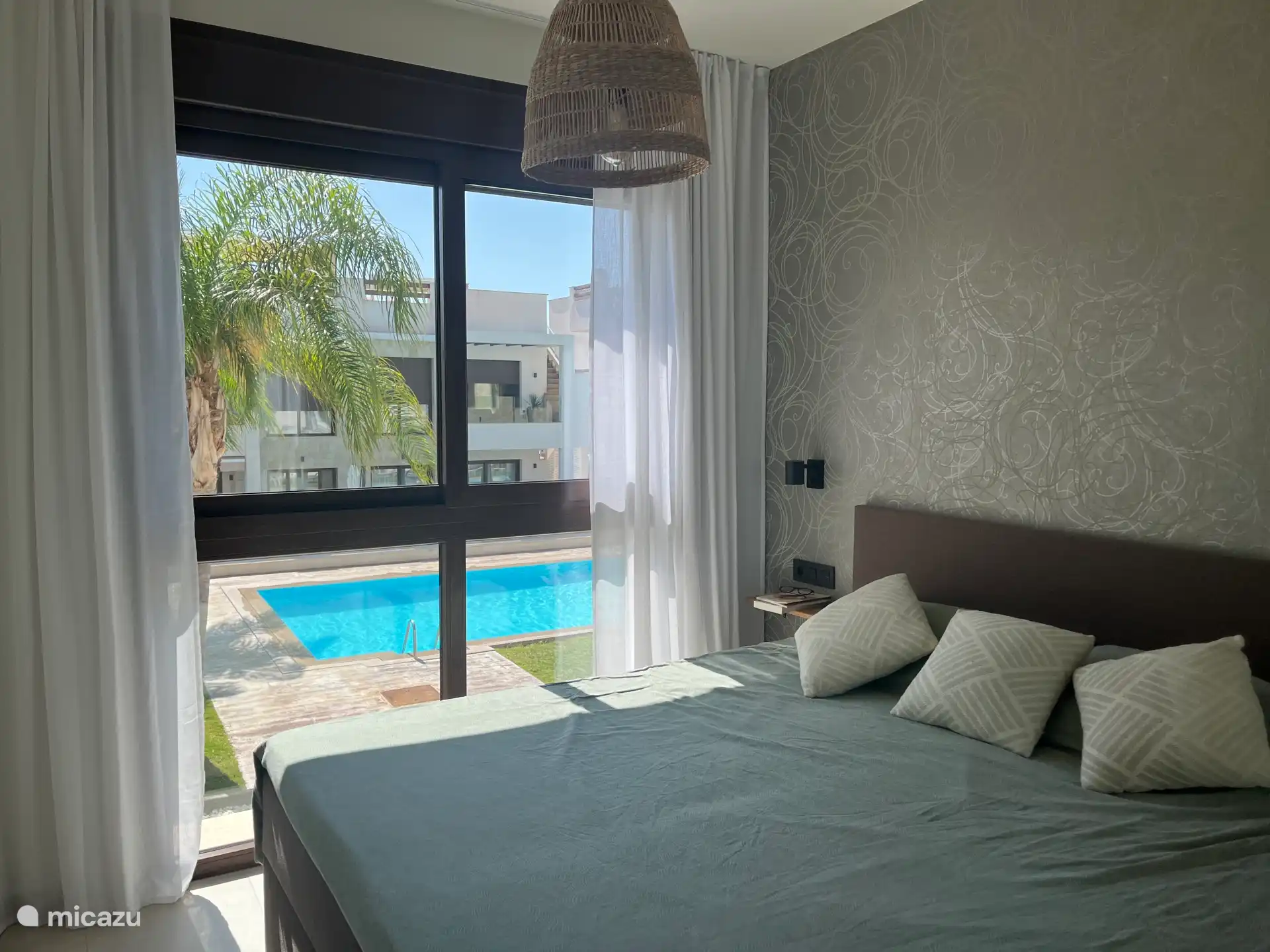 Master bedroom with ensuite bathroom overlooking the pool 