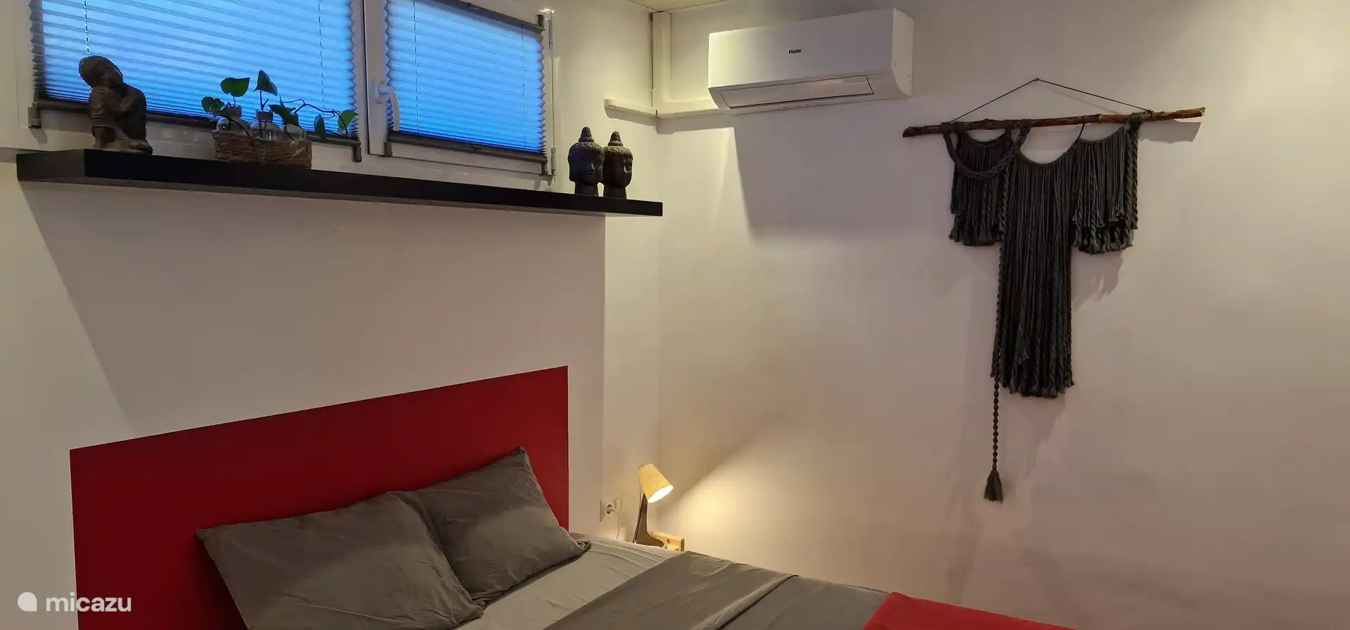 La habitaci&#243;n roja un poco m&#225;s peque&#241;a con ba&#241;o privado, mosquiteras, aire acondicionado y un armario empotrado con puerta corredera de madera.