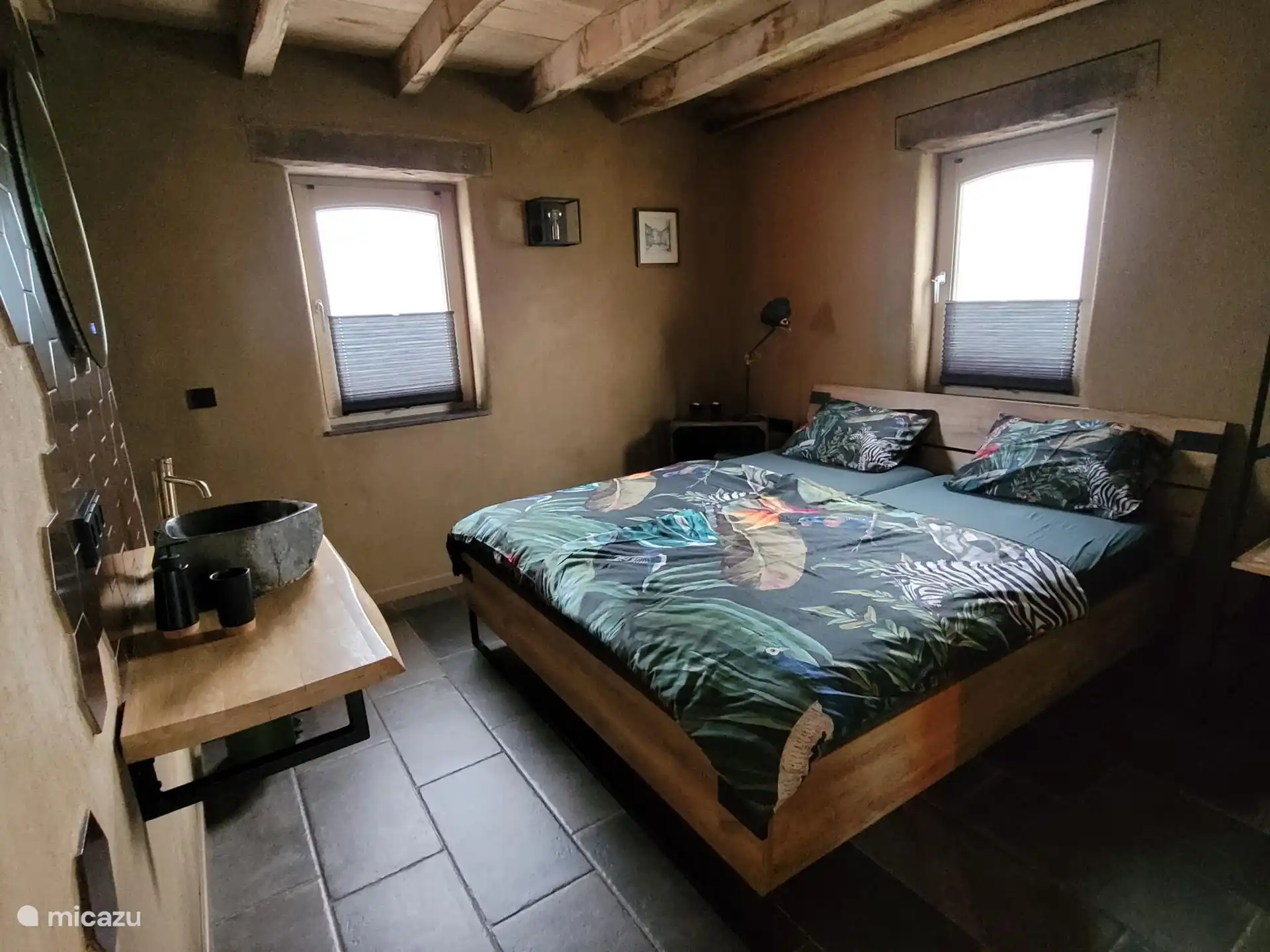 The cozy bedroom is equipped with all modern conveniences, but the clay piece gives you a feeling of the past.