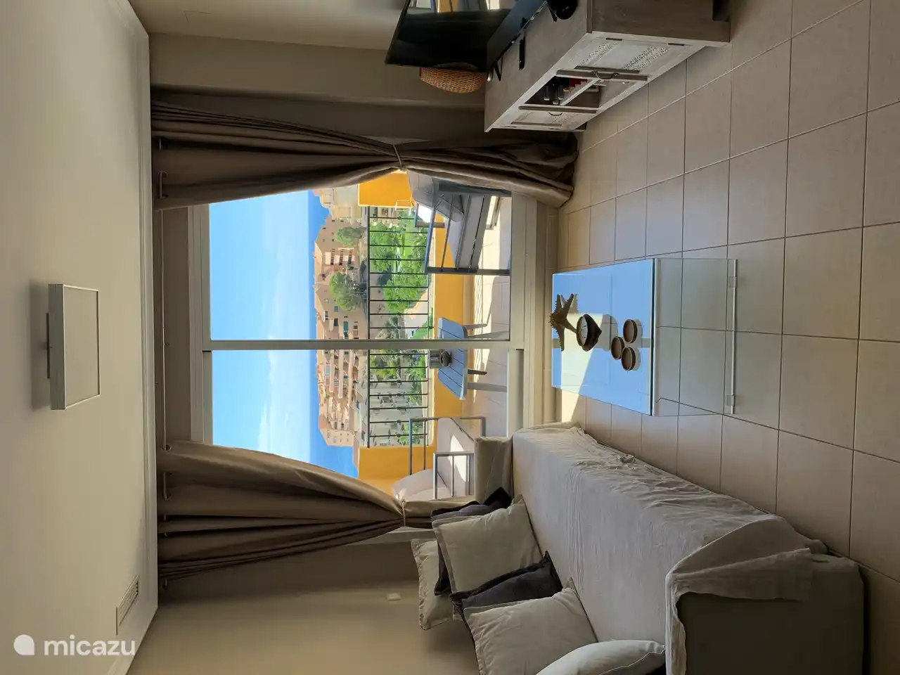 It is also nice to stay in the living room. Here you will see the spacious sofa and you can use the satellite TV with international channels. You can also reach the balcony through the sliding door.