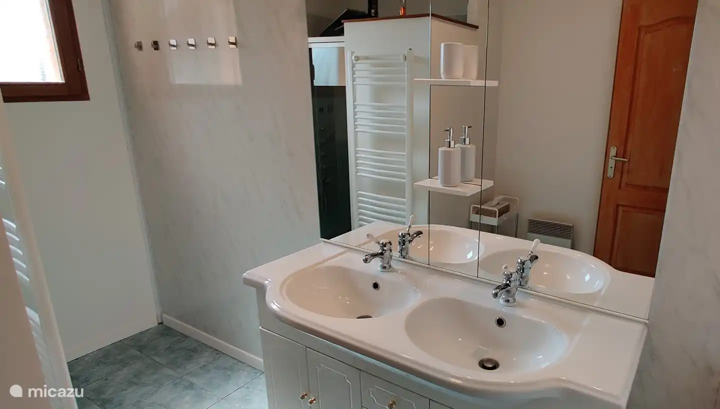 The bathroom is well equipped, including a double sink.