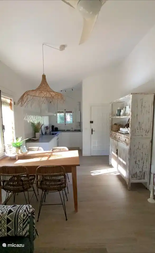 Dining area dining table with 4 chairs. With opening windows. With wooden roller blind of wooden slats on the outside.