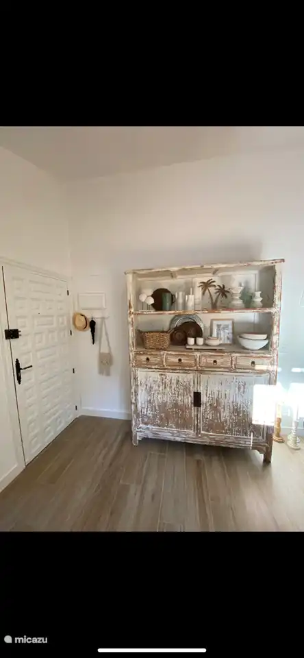 The front door and the sideboard with cutlery, glasses, cups, dishes, placemats, etc., see the photos for