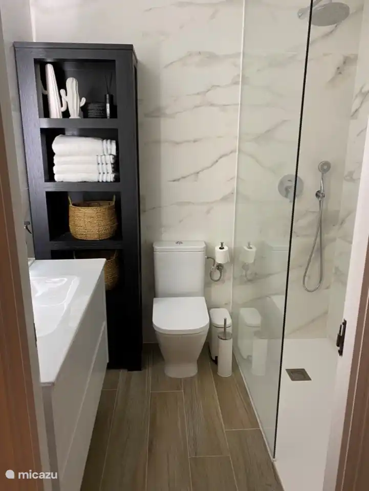 Our beautiful new luxury bathroom with spacious walk-in shower with rain and hand shower, toilet and cupboard. The bathroom is located between the 2 bedrooms.