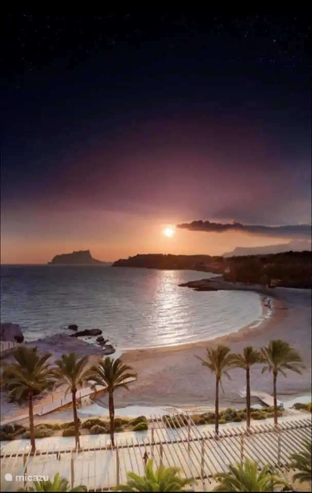 The beach of Moraira with the setting sun.