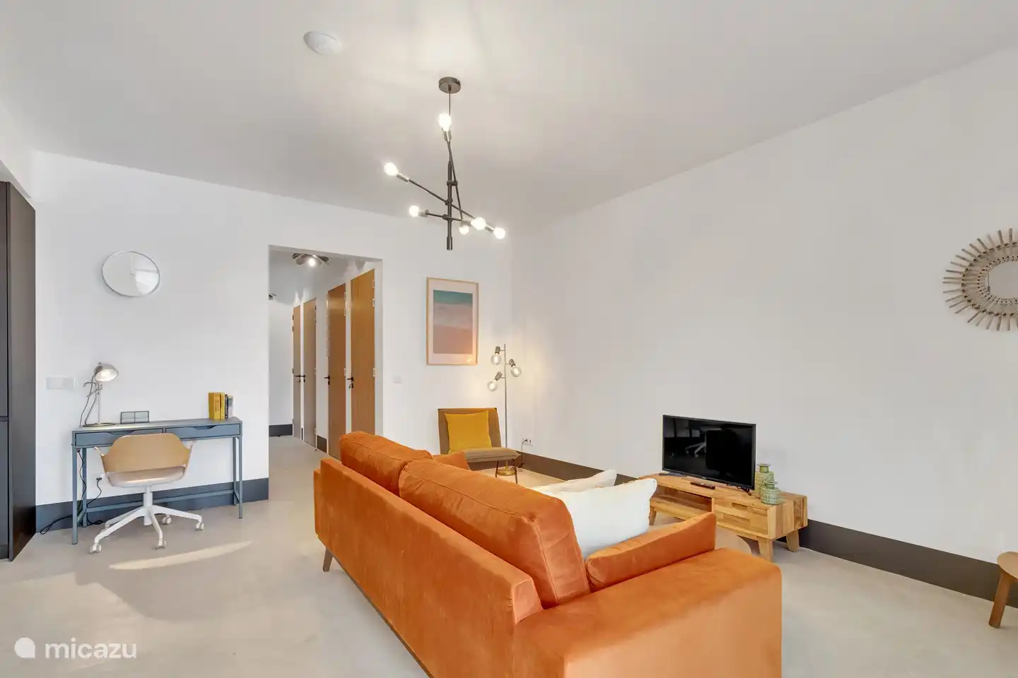 Living room with sofa, relax chair and TV.