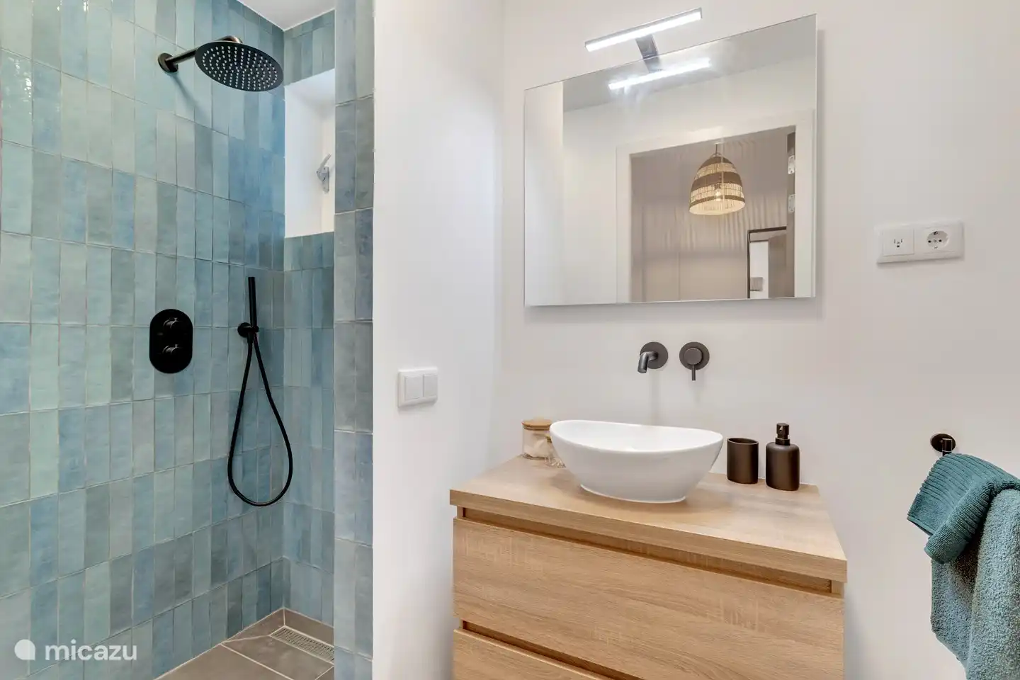 Bathroom with rain shower, sink and toilet.