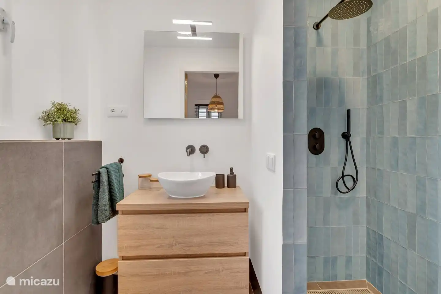 Bathroom with rain shower, sink and toilet.