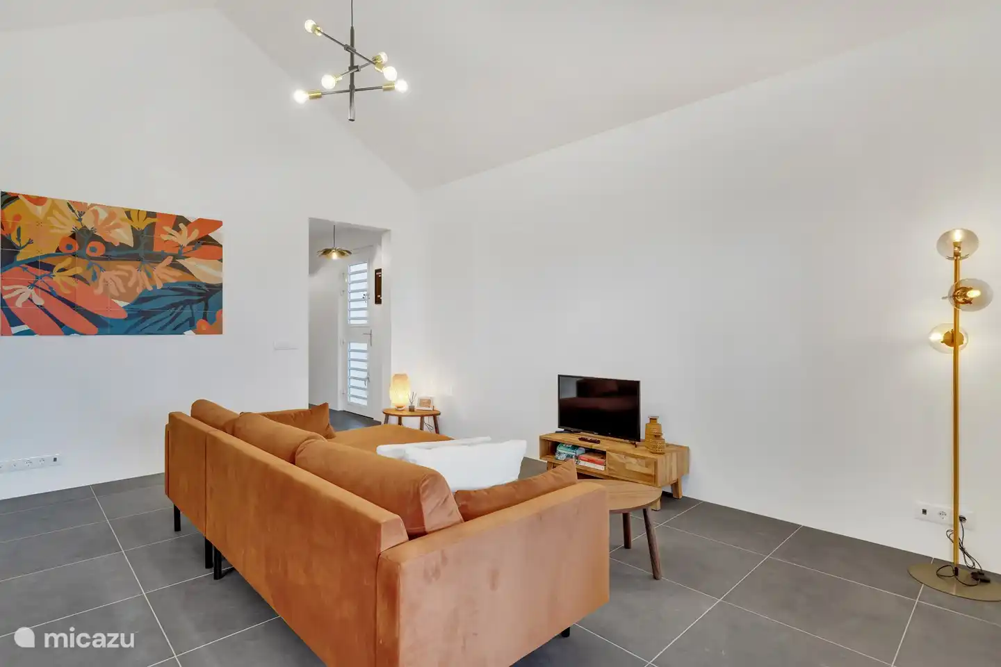 Wohnzimmer mit bequemem Sofa und Fernseher.