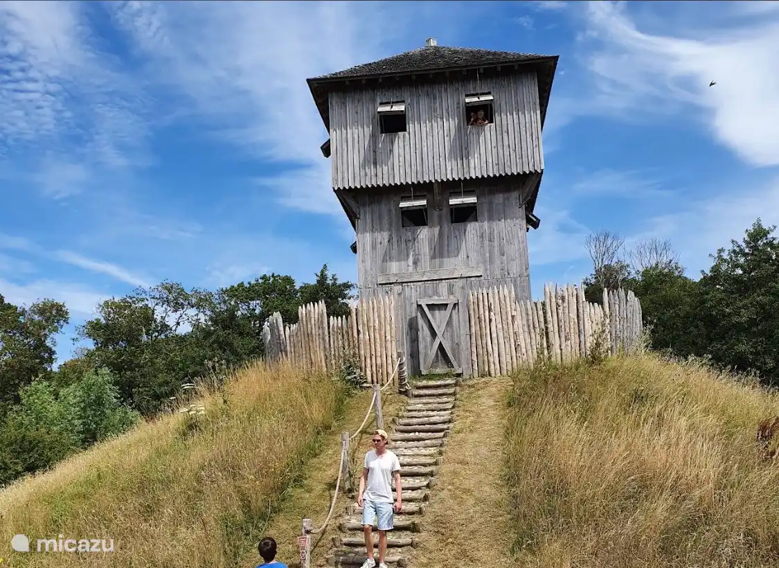 The image shows a wooden reconstruction of a medieval motte-and-bailey castle defense tower located at the Terra Maris museum near Westhove Castle in Oostkapelle, Zeeland, Netherlands