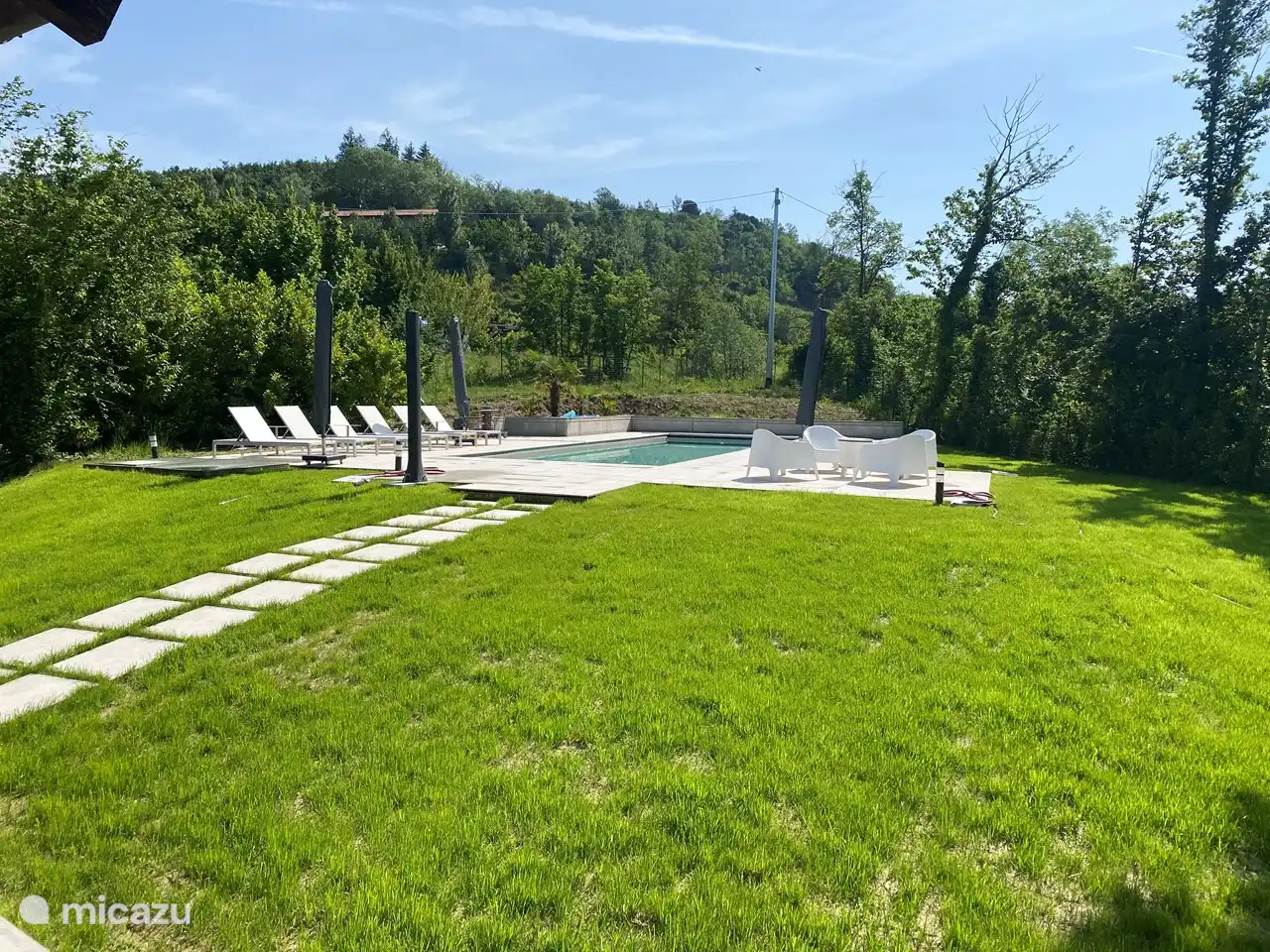 Viele Stühle und Sonnenliegen am Pool