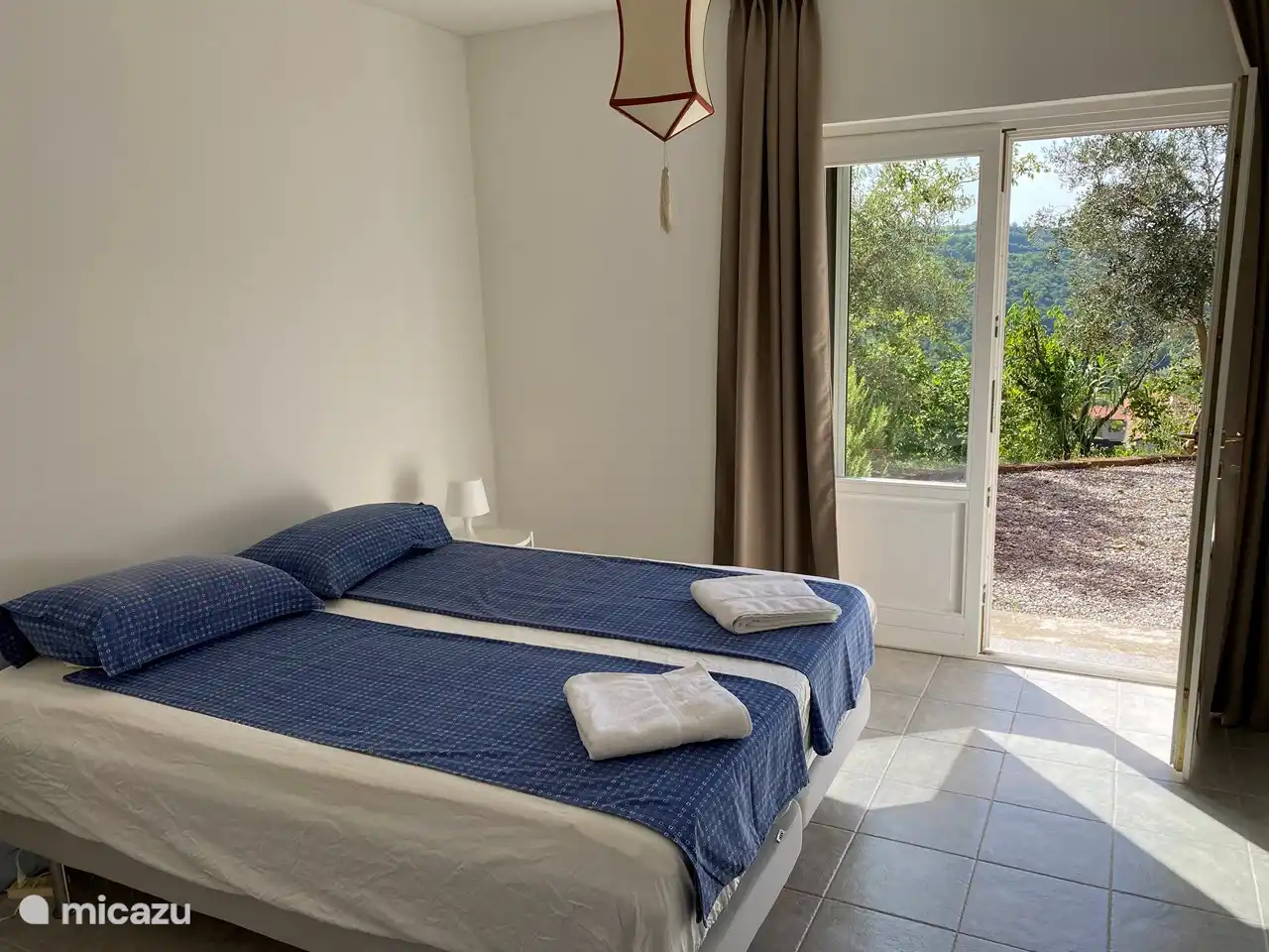 Schlafzimmer im Erdgeschoss mit Terrassentüren zur separaten Terrasse