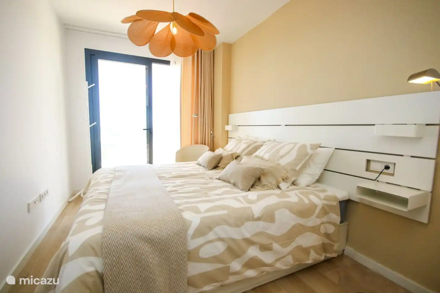 Bedroom 1 with access to balcony and en-suite bathroom. Air conditioning available.