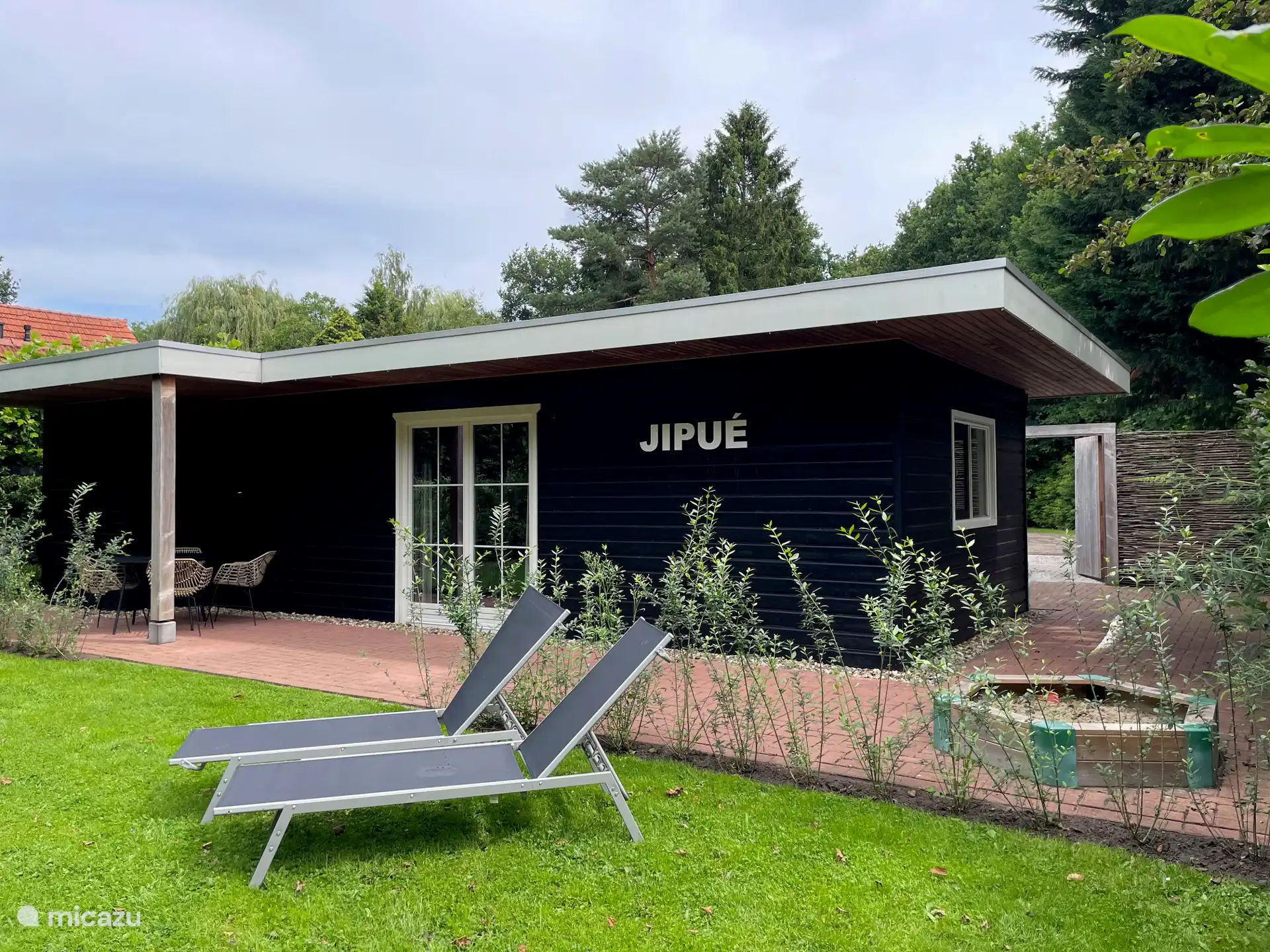holiday home and garden. with sun loungers and sandpit