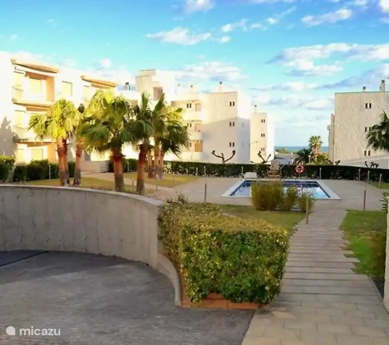 The entrance to the parking garage with the swimming pool in the background