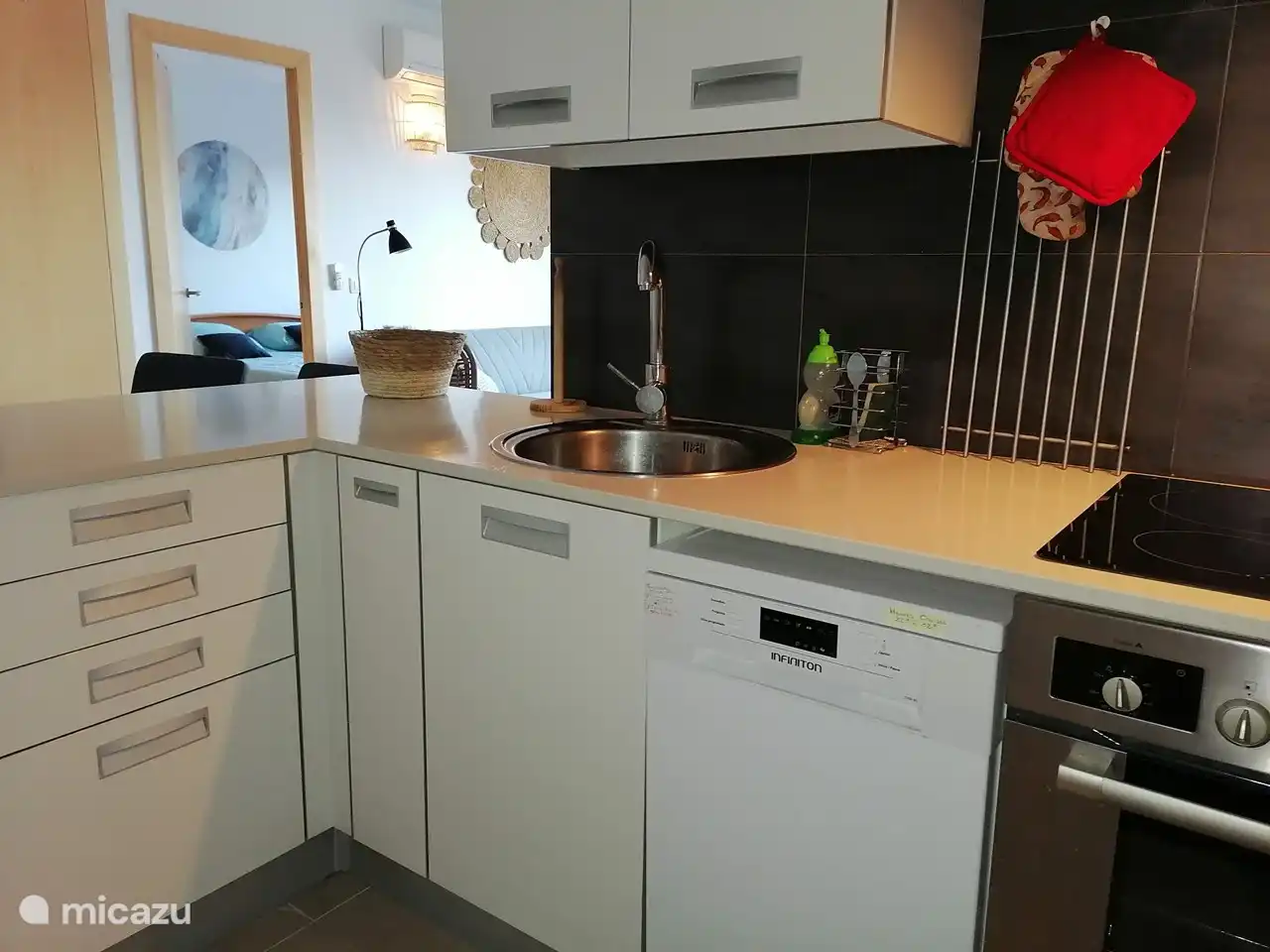 The kitchen with a view of the living room