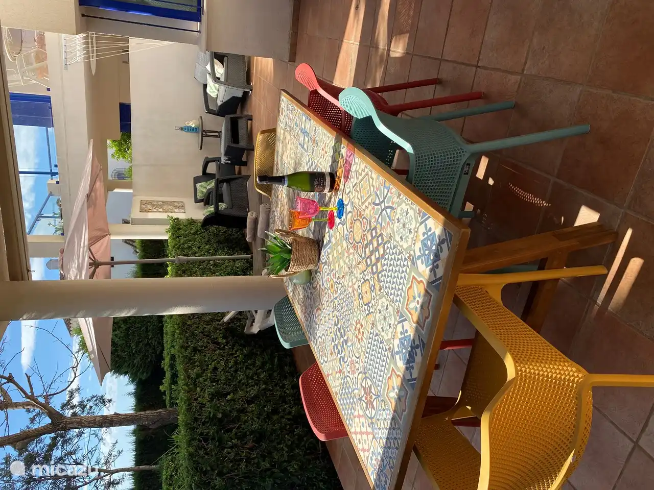 View from the terrace with: large dining table and 6 comfortable chairs. 2 adjustable sun loungers with parasol. Lounge area.