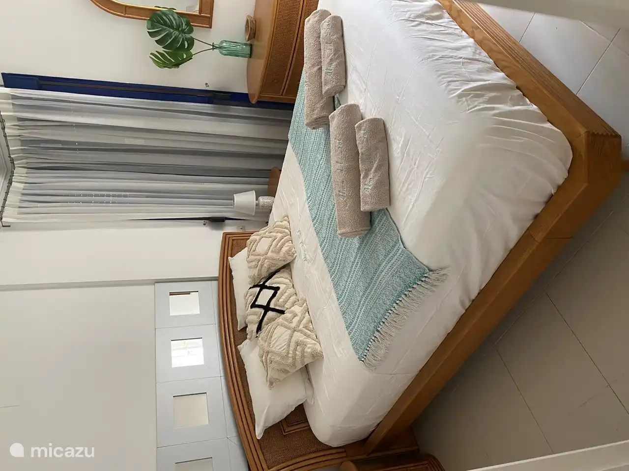 Bedroom 1 with ensuite bathroom. 1 double bed with a bedside table and chest of drawers on both sides. This room features a 3-speed fan.