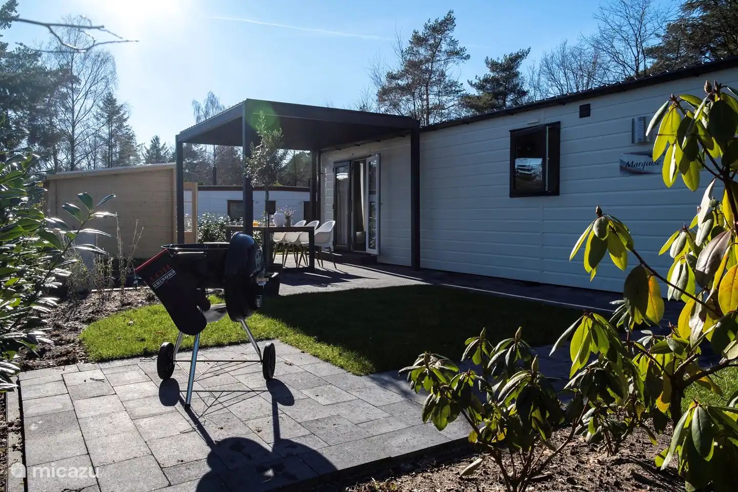 Lovely sitting outside under the roof that can be opened or closed with slats.