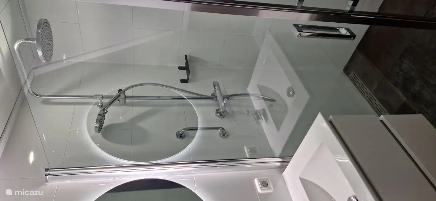 Cuarto de baño con una maravillosa ducha de efecto lluvia, bañera con hidromasaje, calefacción por suelo radiante y lavabo.