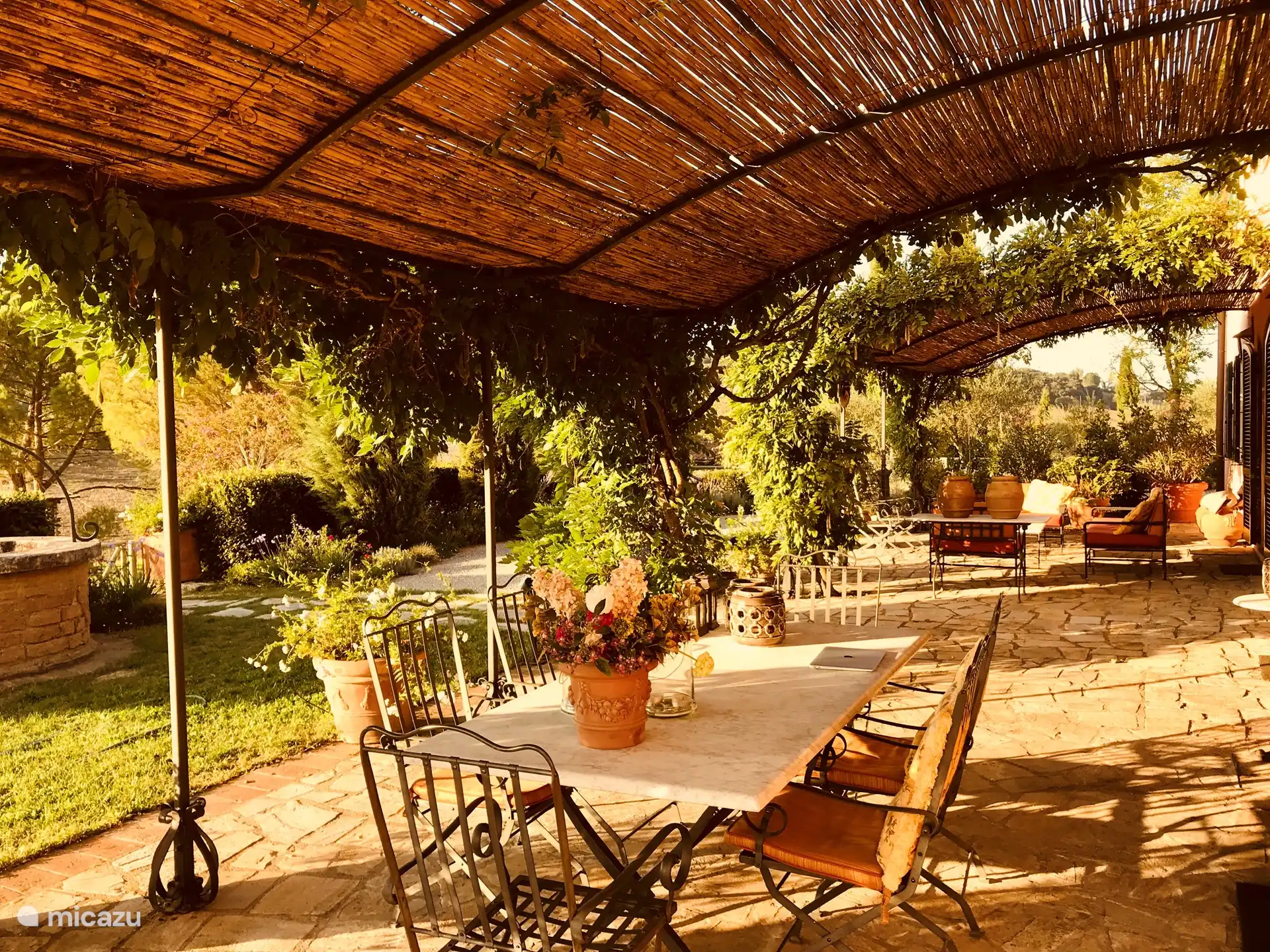 Una terraza con dos cenadores para dar sombra.